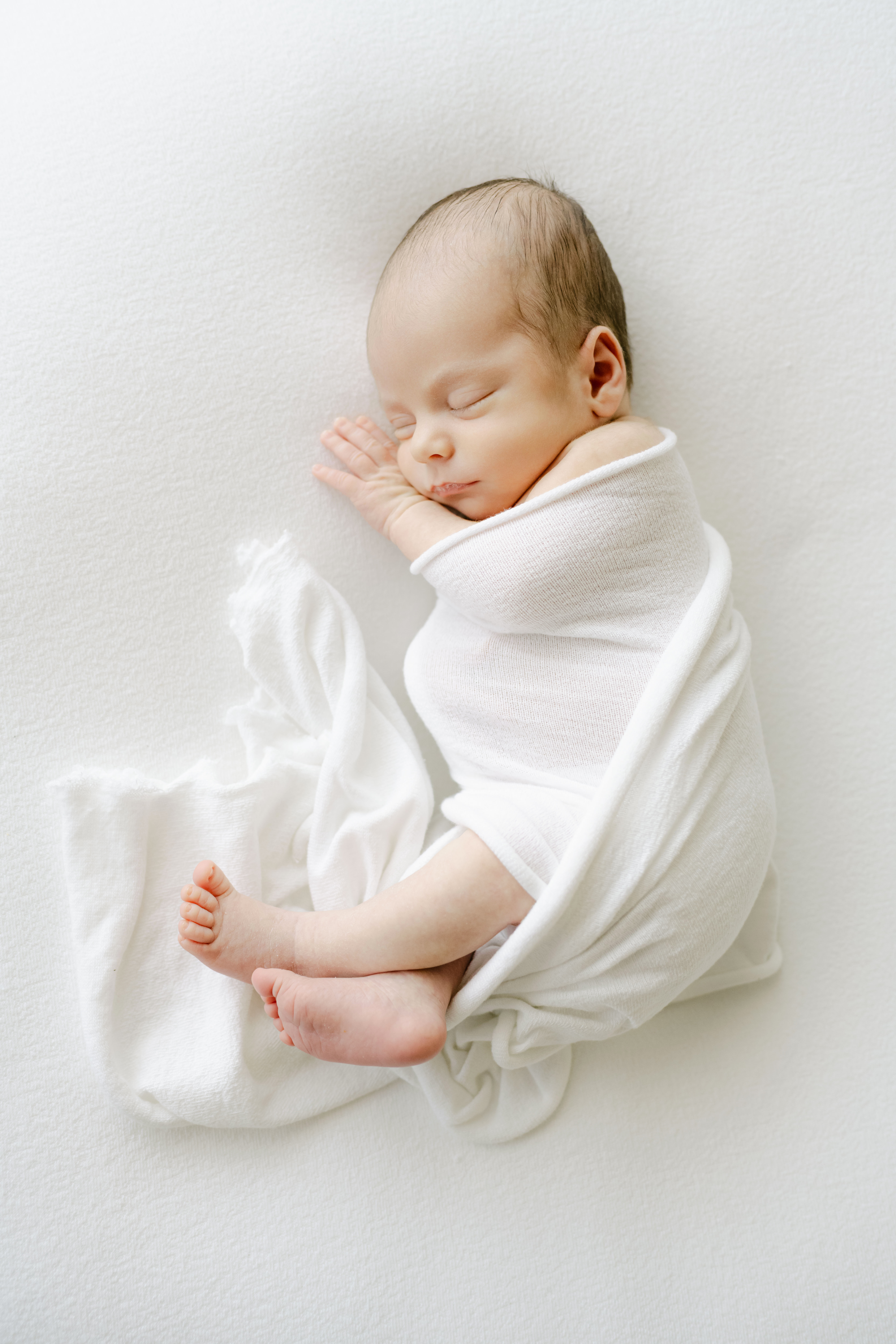 Roswell Newborn Photographer baby wrapped in white.