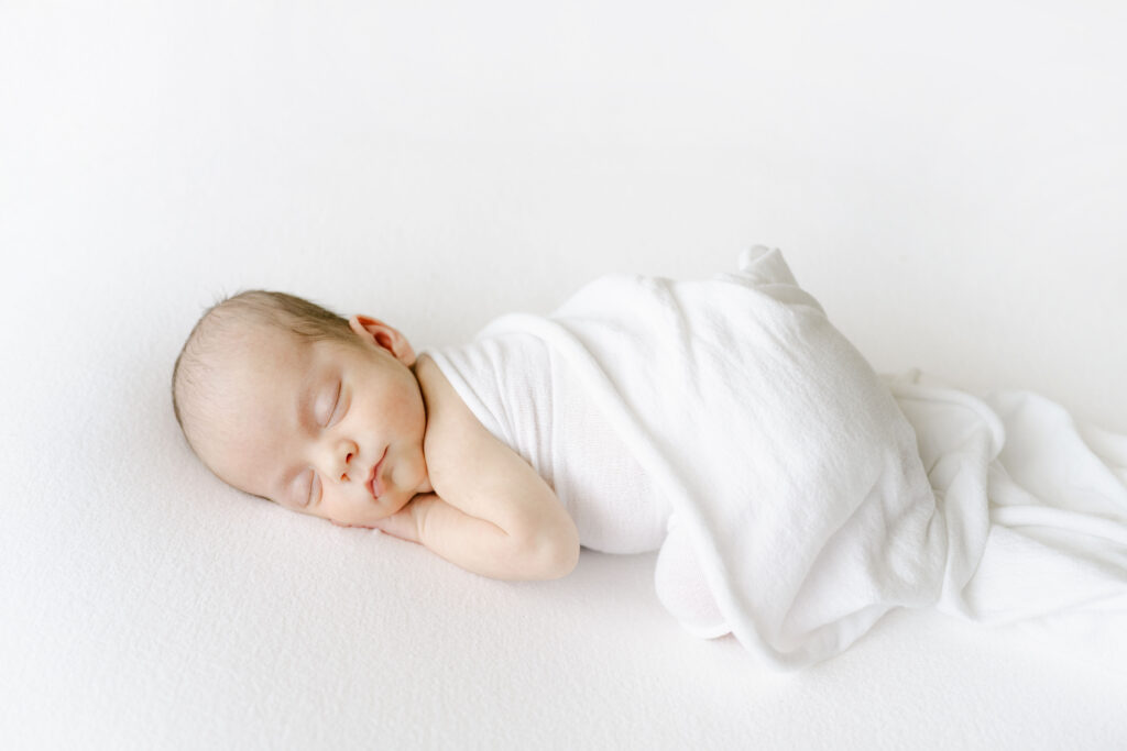 Roswell Newborn Photographer baby alone in white blanket.